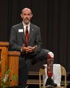 Kent Stoneking, chair of pharmacy practice, reveals his prosthetic leg during an address to first-year pharmacy students. His leg was crushed during a motorcycle accident, but he has used the injury as an opportunity to spread the gospel and inspire people in similar situations. - Photo by Morris Abernathy