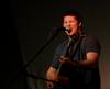 John Monroe, freshman psychology major, hits a high note while singing "Free Fallin'" during the Focus weekend Open Mic Night.  - Photo by Ebbie Davis