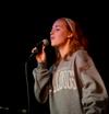 Kelsie Leaf, freshman public relations major, sings the final song at the annual Open Mic Night during Focus weekend. - Photo by Ebbie Davis