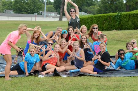 Members of Zeta Tau Alpha celebrate Panhellenic Bid Day together on a slip 'n slide. 