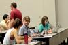 Kirby Lewis (center), senior political science major, talks with other students while waiting for Student Senate to begin in Harvey Auditorium.  - Photo by Anne Richoux