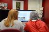 Students on the Cardinal & Cream staff work on creating a page for the Life section of the student newspaper. - Photo by Jacob Moore