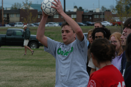 Onion Wayne Campbell throws in a ball from the sidelines during an intramural soccer game.