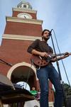 Rob Griffith, junior English major, practices a song before Union Night, a Family Weekend event, in front of Miller Tower. - Photo by Zac Calvert