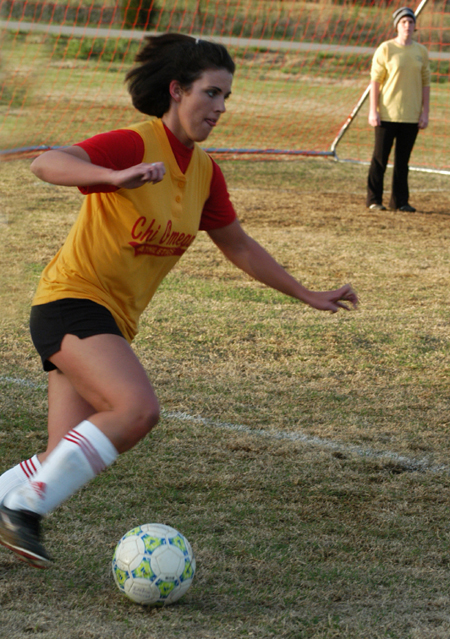 Chi Omega Kerra Kunce drives the ball down field during an intramural soccer game.