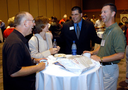 6/15/2004 - Senior Vice President for University Relations Charles Fowler (center) enjoys a light moment with a few friends at the SBC Alumni and Friends Dessert Reception.  Pictured from left to right: Dr. Jerry Winfield, Carolyn Priest, Dr. Fowler and Dr. Mike Priest. (ID: 2111)