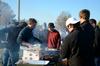 Chris Hawks (left), junior accounting major, grills hamburgers and hotdogs for the pre-game tailgate celebrating Senior Night for the soccer teams.  - Photo by Anne Richoux