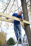 11/6/12 - Dylan Baker, junior engineering major, works on building a swing set for the East Chester site of Mission Jackson, an outreach program of Englewood Baptist Church, during Campus and Community Day. - Anne Richoux