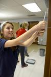 11/6/12 - Laura Little, sophomore Christian ministry and missions major, rolls the youth room walls at Cornerstone Baptist Church during the tenth annual Campus and Community Day. - Ebbie Davis