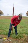 Kenan Keller, junior history major, helps clean the grounds of Parker's Crossroads Battlefield in Henderson County during the tenth annual Campus and Community Day. - Photo by Jacob Moore