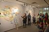 Students and art faculty gather in the art gallery to hear Tai Hwa Goh discuss her work during the opening reception for her exhibit. - Photo by Jacob Moore