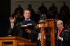 Chris Mathews, associate professor of music and department chair, leads graduates and their friends and families in a Christmas hymn during Fall Commencement. - Photo by Jacob Moore