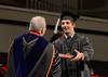 Jordan Norton, broadcast journalism graduate, accepts his diploma from David S. Dockery, president of the university, during Fall Commencement. - Photo by Jacob Moore