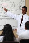 Ashok Philip, assistant professor of pharmaceutical sciences, gives instruction to some pharmacy students. - Photo by Kristi McMurry