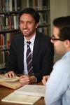 Jason Crawford, assistant professor of English, meets with a group of students in the library.  - Photo by Kristi McMurry