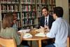 Jason Crawford, assistant professor of English, meets with a group of his students in the library.  - Photo by Kristi McMurry