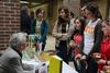 Author Ben Sáenz talks with a group of students during the book signing following his poetry reading.  - Photo by Matt McDaniel