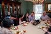 Samantha Adams (center), senior public relations major, talks with Be Our Guest hosts, Bill and Alice Nettles, and other students during dinner in the Nettles' home. - Photo by Anne Richoux