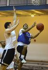 At left, Cole McAdams, senior physical education and health major, reaches to block Tommy Woods, junior digital media studies major, during an intramural basketball game. - Photo by Jacob Moore