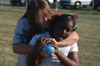 Sophomore Jennifer Winfield, nursing major, tries to fend off a water ballon from a student during TeenKid Impact. - Photo by Lindsay Stavish