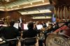 Michael Mann, assistant professor of music, conducts the symphonic band while rehearsing for their Spring concert. - Photo by Anne Richoux