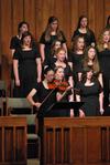 Paige Tang plays the violin along with the women's choir during the Spring Choral Concert at First Baptist Church.  - Photo by Anne Richoux