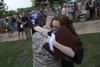 Holly Owens, graduate of music and english, hugs her fiancé after receiving her diploma during Spring Graduation. - Photo by Matt McDaniel