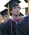 Wil Sloan, history graduate, listens to the announcements by David S. Dockery, president of the university. - Photo by Matt McDaniel