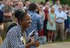 Renee Jones, associate director of the Vocatio Center for Life Calling and Career, congratulates a graduate during the commencement processional held on the Great Lawn. - Photo by Jacob Moore