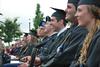 Graduates watch as their fellow classmates receive their diplomas during the 188th Spring Graduation. - Photo by Anne Richoux