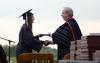 Sam Adams, public relations graduate, receives her diploma from David S. Dockery, president of the university, during Spring Graduation. - Photo by Jacob Moore