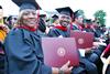 Master of Christian studies graduates, Debra Burroughs and Zedric Clayton, smile after receiving diplomas at Spring Graduation. - Photo by Anne Richoux