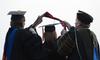 Doctoral graduates receive their hoods during Spring Graduation on the Great Lawn. - Photo by Jacob Moore