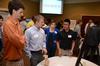 At center left, Cody Giles, senior engineering major, talks about his group's experimentation using an oscillating steam engine with engineering students Shane Caver (left), Lydia DeWolf and Andrew Tan. - Photo by Jacob Moore