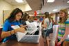 08/228/13 - Melanie Arias, senior social work major, helps freshman Hannah Porter get checked in during move-in day. 