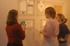 Senior Carrie Brooks discusses some of her graphic design in the Art Gallery. - Photo by Lindsay Stavish