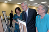 Becky Howard and Joe and Sue Blass look over a display of photos of Dr. Blass' time at Union during his retirement reception. - Photo by Kristen Nicole Sayres