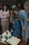 Zeta Tau Alpha members and alumni reminisced over a scrapbook at the All Greek Alumni Reception during Homecoming 2004.  - Photo by Kristen Nicole Sayres