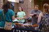 09/269/14 - Brittany Winfee, resident life secretary, and Ken Litscher, director of residence life, help parents gather their itineraries for Family Weekend. 