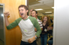 Freshman David Holsinger, broadcasting major, emerges from a classroom in a mock guard-raid with his FOCUS group. - Photo by Kristen Hiller