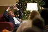 12/343/14 - Dub Oliver, president of the university, leans back to take a photo of the students gathered in the McAfee Commons for Christmas with the Olivers.