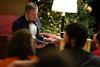 12/343/14 - Dub Oliver, president of the university, reads The Night Before Christmas to the students gathered in the McAfee Commons for Christmas with the Olivers. 