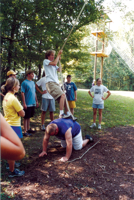 8/19/2003 - Sophomore class president Brad Spencer uses SGA attorney general Matt Oshel to steady himself during a ropes course obstacle at the student leadership retreat before the fall semester. (ID: 2506)