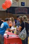 08/226/15 - Lindsey Jakeman, senior business administration major and residence assistant, checks in a new student during new student move-in day in the Fred Delay Gymnasium.