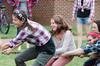 09/272/15 - Craig residents laugh during the tug-of-war in the annual DF Olympics on the Heritage Complex lawn.