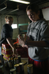 Freshmen Jenny Beffa & Corrie Rose organize cans at RIFA during Day of Remembrance. - Photo by Kristen Nicole Sayres