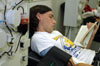 Senior David Clark, creative writing major, uses his donation time to get caught up on some reading. The entire plasma donation process takes roughly an hour and a half which donors can spend relaxing, reading magazines or enjoying the movie shown on various televisions throughout the donation room. - Photo by Amanda Herron
