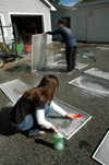 Bess Perrier and Stefi Brazzeal clean window screens at Birth Choice during Day of Remembrance. - Photo by Amanda Herron