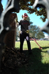 Sophomore Shana Willows rakes leaves at Birth Choice during Day of Remembrance. - Photo by Amanda Herron