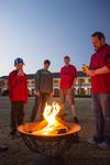 03/65/16 - Ken Litscher, director of Residence Life (on right), lights a fire to warm up the Residence Life Grill Out for Sibling Weekend.